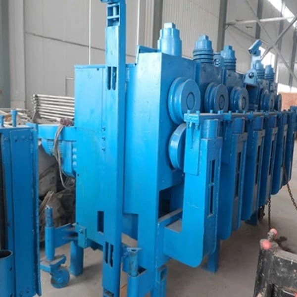 Rollers, frames and adjustment points on a blue forming assembly.