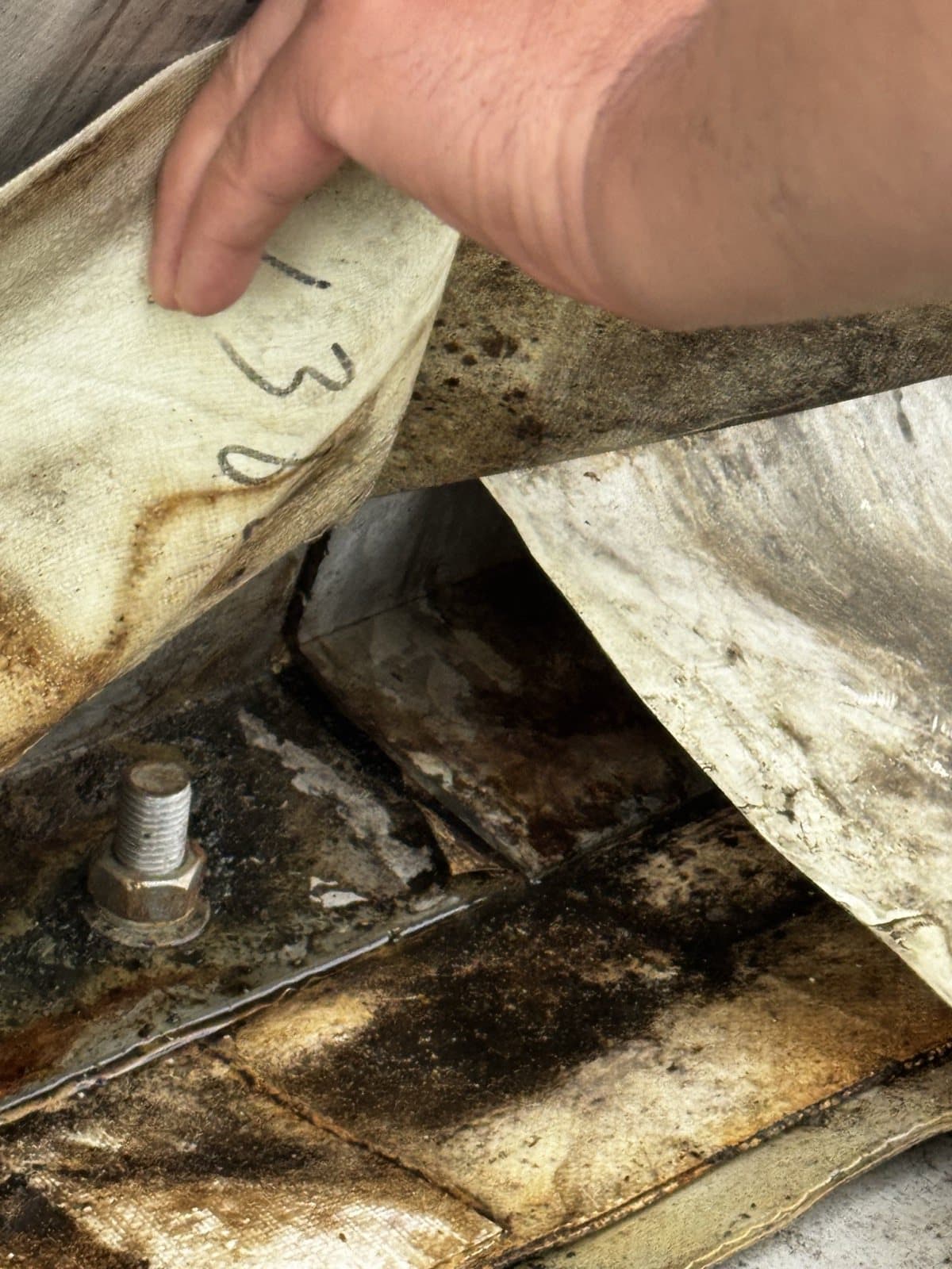 Clamping and sealing interface exposed beneath the old membrane edge